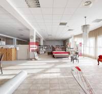 Interior of a building with furniture, a red sofa, a bed, and tables with documents.