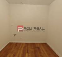 A room with white walls and a wooden floor in a 4-room apartment.