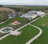 Playground and green areas around family houses in Slovenský Grob.