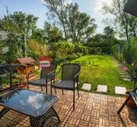 A garden of a family house in Slovenský Grob with a terrace, grill, and lawn.