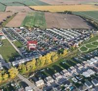 Aerial view of a residential area and surrounding landscape in Slovenský Grob.