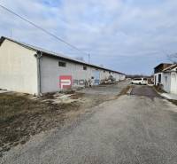 On Partizánska Street, warehouses and halls are visible next to the road.