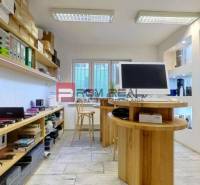 Commercial space with shelves full of documents, devices, and a computer on the desk.
