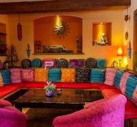 A colorful room with comfortable cushions and wooden decorations in hotels and guesthouses.