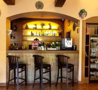 A bar counter with three stools and decorations in the interior of hotels and guesthouses.