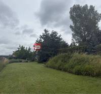 A grassy plot surrounded by greenery in Marianka on Na Tálkoch, ideal for living.