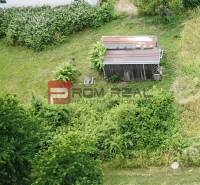 Land - housing in Marianka on Na Tálkoch street with greenery and a small building.