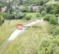 Residential plots in Marianka on Štúrova Street, surrounded by greenery and houses.