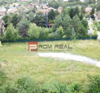 Residential plots in Marianka on Štúrova Street surrounded by greenery and family houses.
