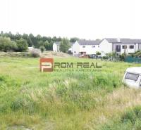 Greenery and caravans near family houses on residential plots in Marianka on Na Ovsisku Street.
