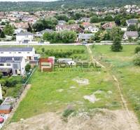 Residential plots in Marianka on Na Ovsisku Street, surrounded by green gardens and houses.