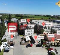 Industrial area on Púchovská Street in Bratislava III with restaurants and warehouses.