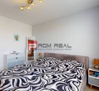 Bedroom with a bed, mirror, and nightstand in a 3-room apartment.