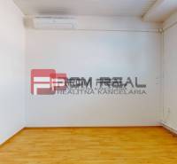 Empty room with light walls, wooden floor, radiator, and air conditioning. Warehouses and halls.