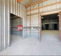 Interior of warehouses and halls with large welded doors and steel walls.
