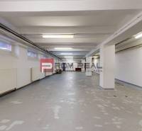 Interior space with lights and white walls suitable for warehouses and halls.