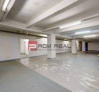 Interior of warehouse spaces with bare walls and several tables. Warehouses and halls.