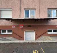 Entrance to warehouses and halls on Púchovská Street in Bratislava III with parking spaces.