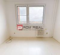Empty room with a window and a radiator in a 4-room apartment.
