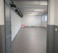 Empty room with gray walls and floor, lighting and ventilation duct in the warehouse and hall.