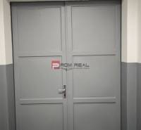 Gray metal double-door gate in warehouses and halls.