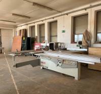 Interior of manufacturing premises with woodworking machines and wooden materials on Nova Street in Pezinok.