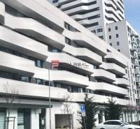 A building with balconies on Údernícka Street in Bratislava V, garages in the foreground.