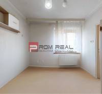 A room with a shelf and a cabinet in a family house, soft shades, a room with a window.