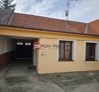 A family house on Slnečná Street in Pezinok with a garage and a satellite dish.