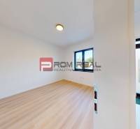 A spacious room with wooden flooring and white walls in a 3-room apartment.
