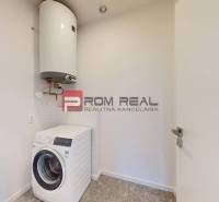 Washing machine and boiler in the utility room of a 3-room apartment.