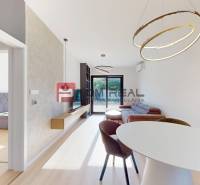 Living room in a 3-room apartment with a dining table and access to the terrace.