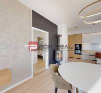Interior of a family house with a kitchen, dining table, and pendant lighting.