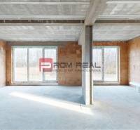 Interior of a family house with brick walls and large windows.