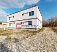 A family house in Dunajská Streda with a gravel driveway and a low-maintenance garden.