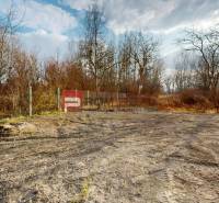 A free plot of land bordered by a fence near the forest in Dunajská Streda, ideal for a family house.