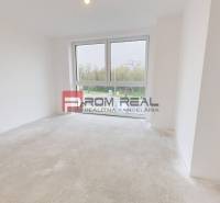 An empty room with a large window in a family house, waiting to be furnished.