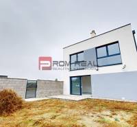 A family house on Bottova Street in Miloslavov with a landscaped plot and fencing.