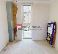 An empty room with plumbing installation for a future bathroom in a family house.