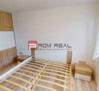 Bedroom in a 3-room apartment with wooden flooring and a wardrobe.