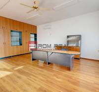 Office spaces with wooden floors, a fan, and built-in wardrobes, available for rent.