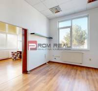 Interior of an office with an empty room, sliding doors, and a chair with the British flag.