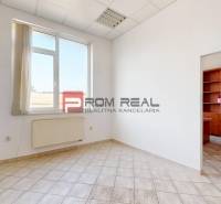 Office space with a window, radiator, and built-in wardrobes. Simple interior.