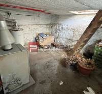 Basement in a family house, with a boiler and storage on a street in the center.