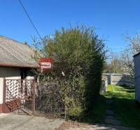 Family house with a yard, gate, and greenery, in the center of the village.