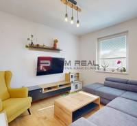 A living room with a comfortable sofa and a yellow armchair in a 3-room apartment.