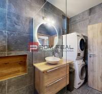Bathroom in a 3-room apartment, with a mirror, cabinet, and a washer with dryer.