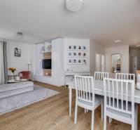 Bright living room with a dining table and a sofa in a 3-room apartment.