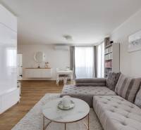Living room in a three-room apartment with a stylish sofa and minimalist furniture.