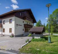 Recreational apartment in the High Tatras with parking, lawn, and sunny weather.